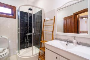 a bathroom with a sink and a shower and a toilet at Casa do Faial in Santana +33 photos