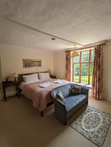 a bedroom with a bed and a couch at Old Manor House in Shepperton
