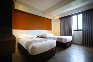 a hotel room with two beds and a window at PROXY by The Oriental Albay in Legazpi +26 photos