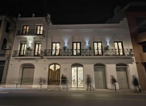 a building with people walking in front of it at night at Salon Suites in Tremp
