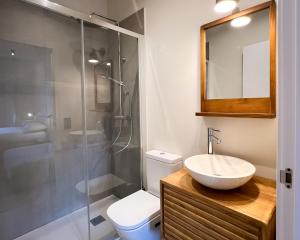 a bathroom with a sink and a shower at Salon Suites in Tremp +24 photos