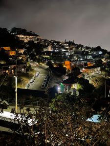a city at night with cars parked on a street at Bo-Kaap Double Room with High Ceiling in Cape Town