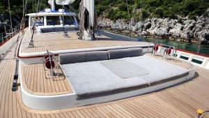 a boat with a bed on the deck of a boat at gold in Fethiye