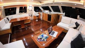 a living room of a yacht with a laptop on a table at gold in Fethiye