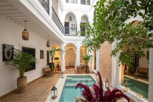 an indoor swimming pool in a house with plants at Riad Dar Beldia and Spa in Marrakesh