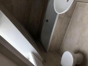 a bathroom with a shower and a toilet and a sink at Seaside-Amrum-18 in Norddorf
