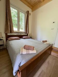a bedroom with a large bed with two towels on it at Wild Side in Mollia