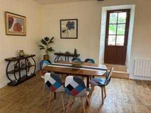 a dining room with a wooden table and chairs at gite 4 le refuge in Aubeterre-sur-Dronne +14 photos