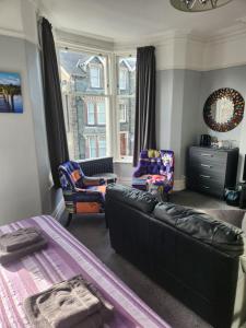 a living room with a couch and a chair at Herdwick Guest House in Keswick