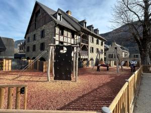 a playground in front of a building at Appartement spacieux en duplex in Saint-Lary-Soulan