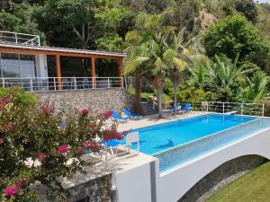 a villa with a swimming pool and a resort at Quinta do Mar in Água de Pau