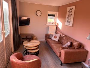 a living room with a couch and a table at Appartement Halfweg in Ballum