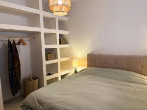 a bedroom with a bed and a lamp and shelves at Vila Espinosa in Trebinje +25 photos