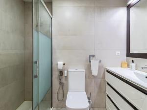 a bathroom with a toilet and a shower and a sink at Alojamientos Marte apartamento a pie de playa y garaje in Suances +15 photos