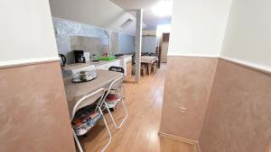 a kitchen with a table in the middle of a room at Casa El Gringo in Tîrnăveni
