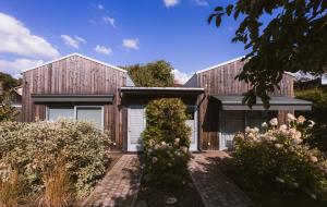a home with a wooden house with a garden at Villa Rosalie in Pärnu