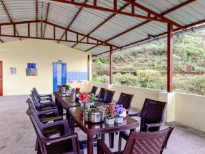 a group of tables and chairs with flowers on them at Kodai Hillscape in Kodaikānāl