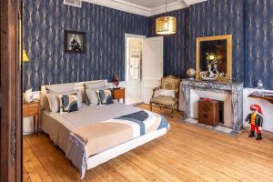 a bedroom with a large bed and a fireplace at château de Puymoger in Javerlhac-et-la-Chapelle-Saint-Robert +25 photos