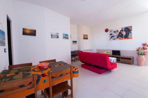 a living room with a red couch and a table at aparthotelboavista-net in Sal Rei