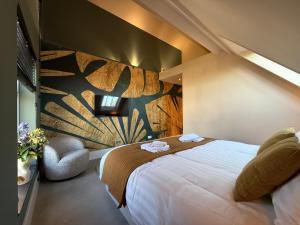 a hotel room with a large bed and a wall mural at B&B Louwi in Breugel