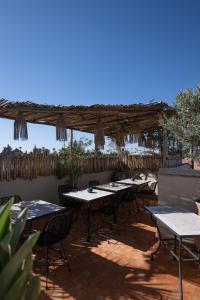 a group of tables and chairs on a patio at Riad Dar Beldia and Spa in Marrakesh