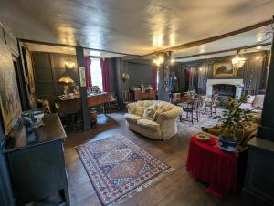 a living room with a couch and a table at Old Manor House in Shepperton
