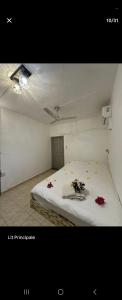 a bedroom with a bed with flowers on it at Naturelle Évasion in Grand-Baie