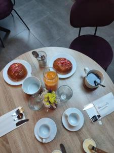 a table with plates of food on top of it at Chambres d'hôtes Atypik in Dieppe +28 photos