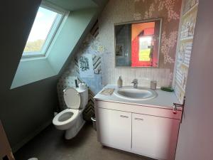a bathroom with a sink and a toilet at Escapade de charme à Questembert in Questembert