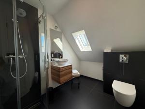 a bathroom with a shower and a toilet and a sink at B&B Louwi in Breugel +45 photos
