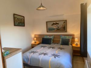 a bedroom with a bed and a picture on the wall at La Requeyrie in Montignac