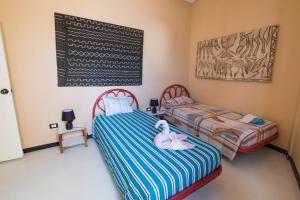 two beds in a room with a chalkboard on the wall at aparthotelboavista-net in Sal Rei