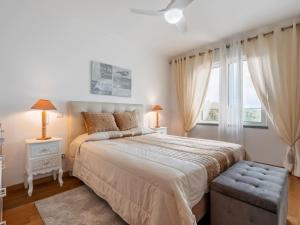 a bedroom with a large bed and a window at Tamariz Flat in Santa Cruz