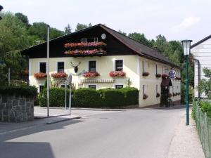 a white house with flower boxes on the side of it at Landhaus Ingrid in Loich