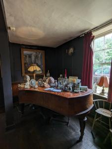 a room with a table with many items on it at Old Manor House in Shepperton