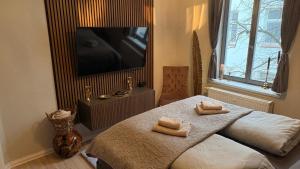 a bedroom with a bed with two towels on it at Apartment Baltica in Rostock +5 photos