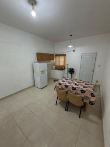 a kitchen with a table and chairs in a room at Apart Sur Catriel in Catriel