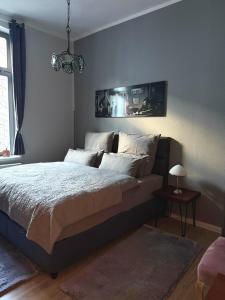 a bedroom with a large bed and a table at Apartment Baltica in Rostock