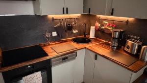 a kitchen with a wooden counter top with a sink at Apartment Baltica in Rostock