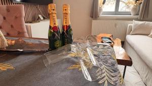 three bottles of wine on a table in a living room at Apartment Baltica in Rostock