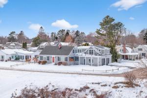 a home in a residential neighborhood with snow at Modern Waterfront Apt with Bay Views in Falmouth