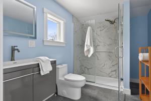 a bathroom with a toilet and a shower at Modern Waterfront Apt with Bay Views in Falmouth +21 photos