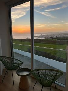 a view from a room with two chairs and a window at Azorescape in Lagoa