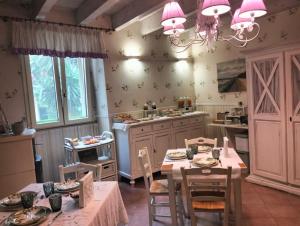a kitchen with a table and chairs and a chandelier at Bed & Breakfast De Nittis - Meridia Collection in Barletta