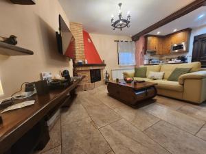 a living room with a couch and a table at Apartamentos Fuentevieja in Arbancón