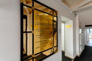 a glass display case in a hallway with bottles of wine at Bofima Apartments in Kotor