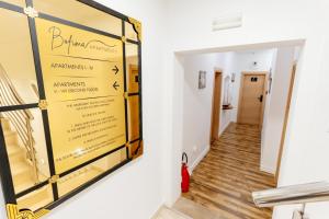 a room with a window with a sign on the wall at Bofima Apartments in Kotor