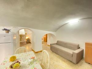 a living room with a couch and a table at Lo Scoglio Bianco in Gallipoli +34 photos