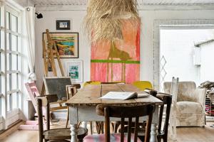 a dining room with a wooden table and chairs at By The Bay A Thatched House Lies So Beautifully in Nørre Åby
