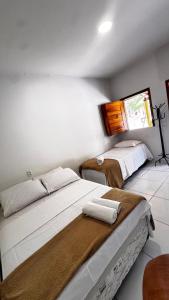 a bedroom with two beds with towels on them at Pousada e restaurante trilha da capivara in Coronel José Diaz +4 photos